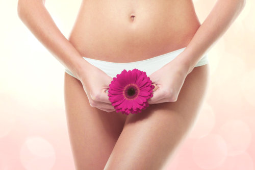 Gynecology concept. Young woman with flower